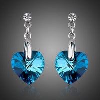 KHAISTA dark blue crystal heart drop earrings on white background