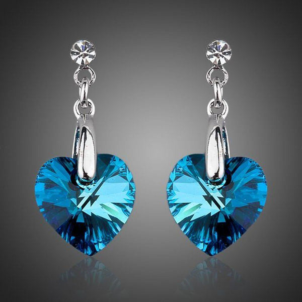 KHAISTA dark blue crystal heart drop earrings on white background