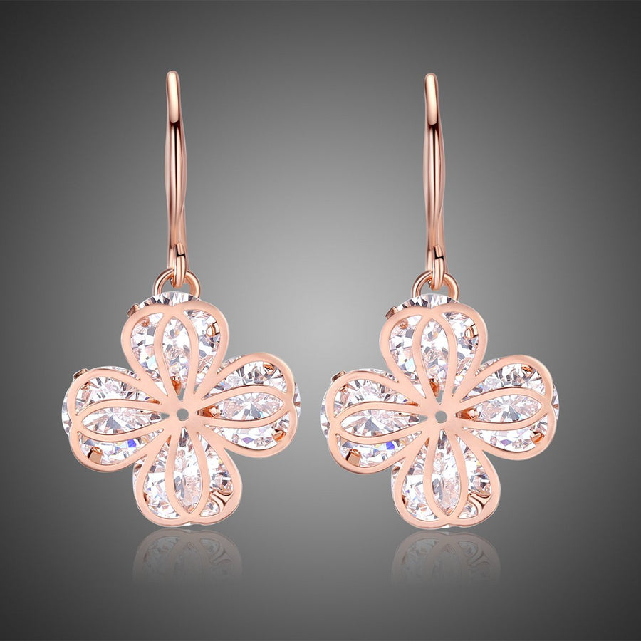 KHAISTA crystal flower drop earrings on white background