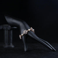 Side angle view of KHAISTA crystal flowers pearl bracelet