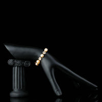 Side angle view of KHAISTA crystal flower pearl chain bracelet