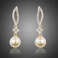 KHAISTA crystal leaf pearl drop earrings on white background