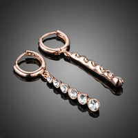 Close up of KHAISTA crystal steps drop earrings