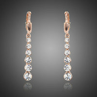 KHAISTA crystal steps drop earrings on white background