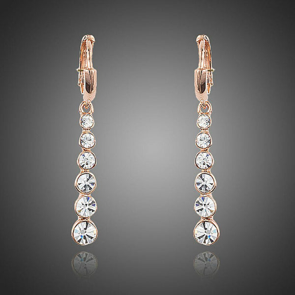 KHAISTA crystal steps drop earrings on white background