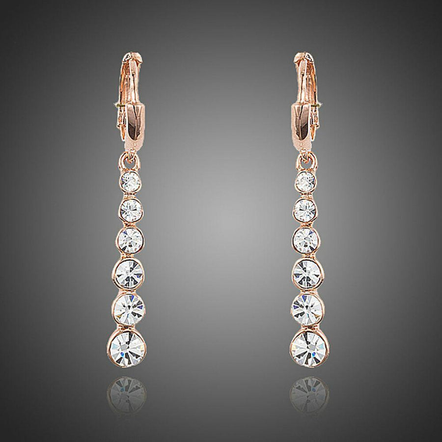 KHAISTA crystal steps drop earrings on white background