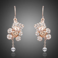 KHAISTA crystal teddy bear earrings on white background