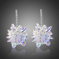 KHAISTA crystal dangle earrings on white background