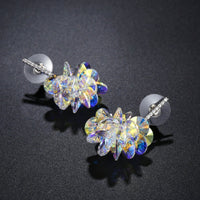 Side angle view of KHAISTA crystal dangle earrings