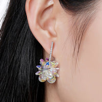 Close up of KHAISTA crystal dangle earrings