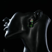 Side angle view of KHAISTA cube green leaf crystal drop earrings