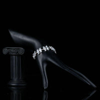 Side angle view of KHAISTA CZ flower garland bracelet
