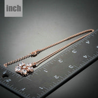 Side angle view of KHAISTA CZ flower pendant necklace