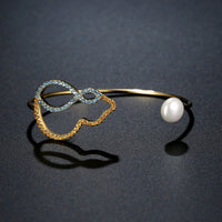 Side angle view of KHAISTA cubic zirconia pearl bangle
