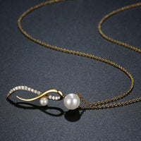 Side angle view of KHAISTA cubic zirconia pearl pendant necklace