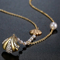 Pendant detail on KHAISTA CZ shell long pendant necklace