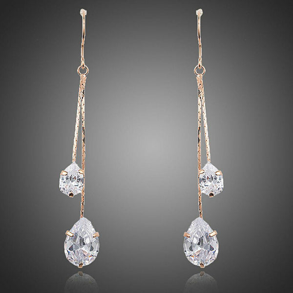 KHAISTA crystal swing drop earrings on white background