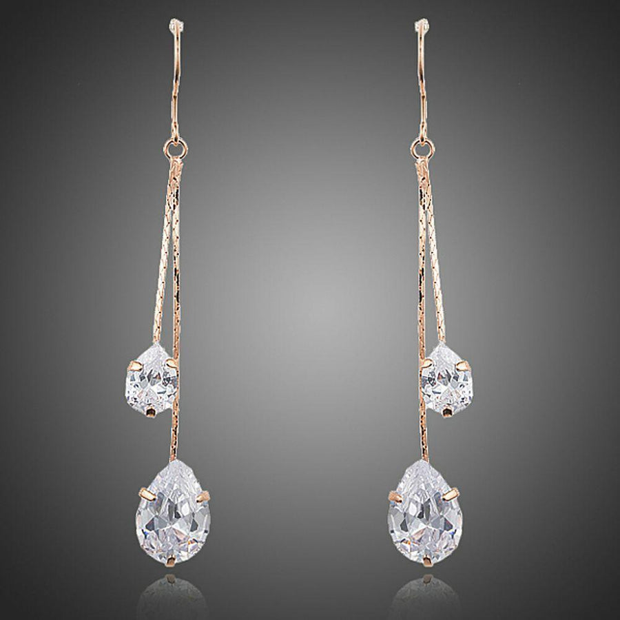 KHAISTA crystal swing drop earrings on white background