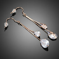 Close up of KHAISTA crystal swing drop earrings
