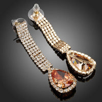 Close up of KHAISTA caramel CZ teardrop earrings