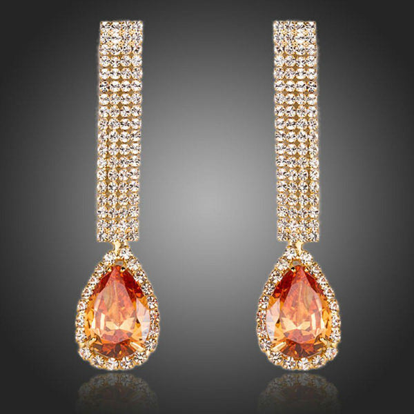 KHAISTA caramel CZ teardrop earrings on white background