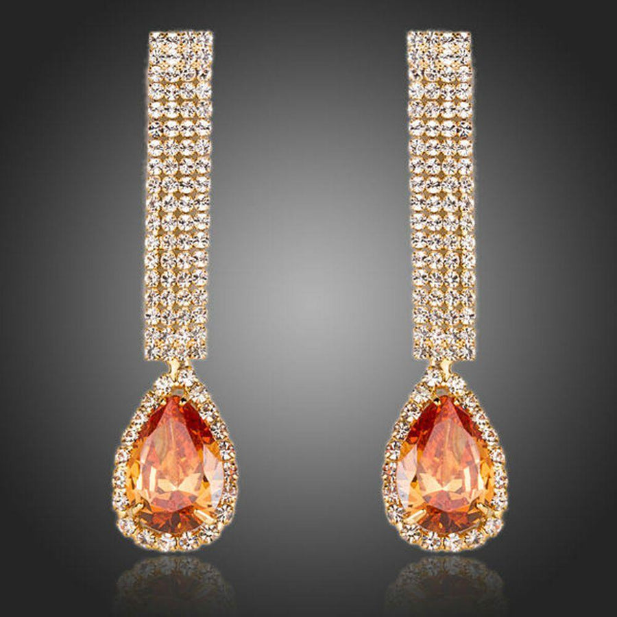 KHAISTA caramel CZ teardrop earrings on white background
