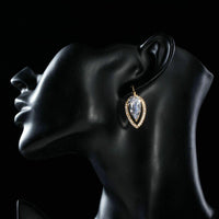 Side angle view of KHAISTA CZ water drop dangle earrings
