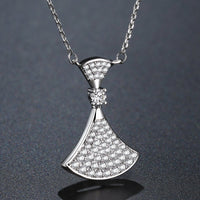 Side angle view of KHAISTA white gold CZ pendant necklace