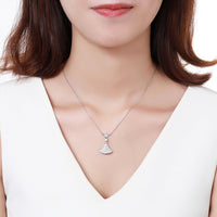 Close up detail of KHAISTA white gold CZ pendant necklace