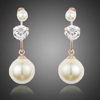 KHAISTA CZ pearl drop earrings on white background