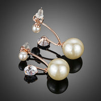 Close up of KHAISTA CZ pearl drop earrings