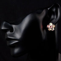Side angle view of KHAISTA daisy flower crystal stud earrings