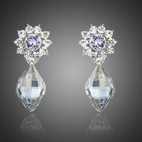 KHAISTA dangling crystal drop earrings on white background