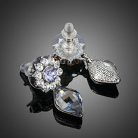 Close up of KHAISTA dangling crystal drop earrings