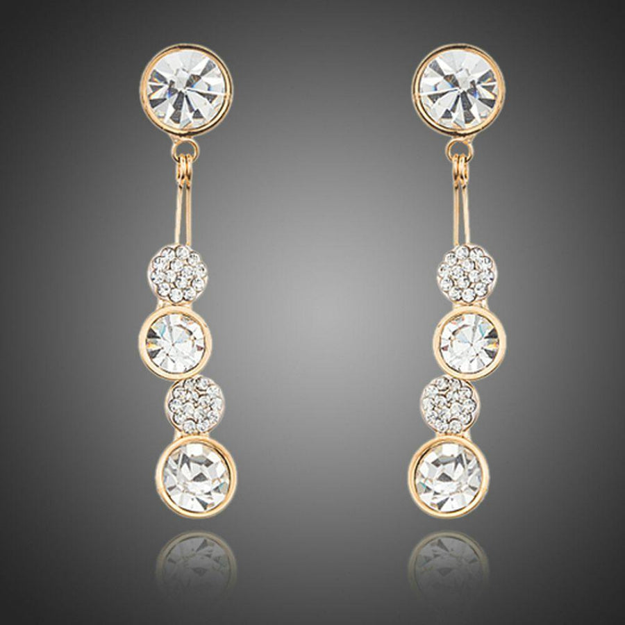 KHAISTA dangling crystal drop earrings on white background