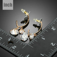 Close up of KHAISTA dangling CZ drop earrings