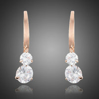 KHAISTA dangling CZ drop earrings on white background