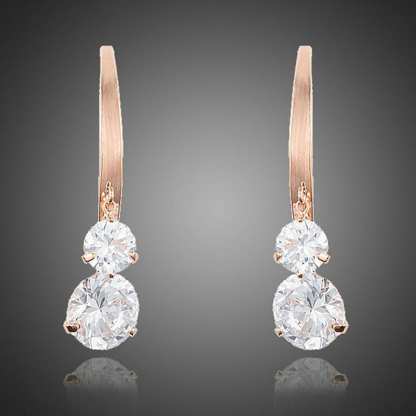 KHAISTA dangling CZ drop earrings on white background