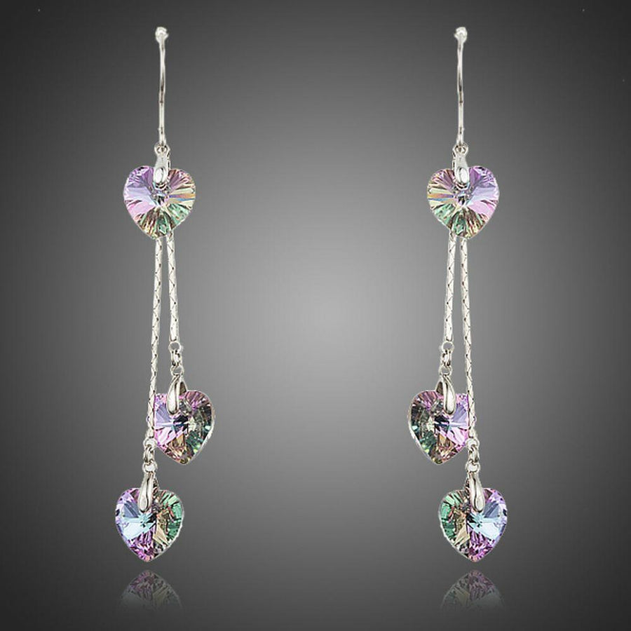 KHAISTA dangling heart crystal drop earrings on white background