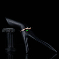 Side angle view of KHAISTA dark green CZ butterfly chain bracelet