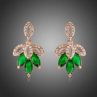 KHAISTA dark green leaves design drop earrings on white background