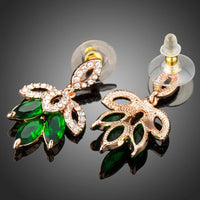 Close up of KHAISTA dark green leaves design drop earrings