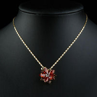 Close up detail of KHAISTA dark red flower CZ chain necklace