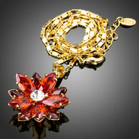 Side angle view of KHAISTA dark red flower CZ chain necklace