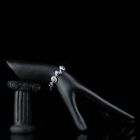 Side angle view of KHAISTA dark blue crystal chain bracelet