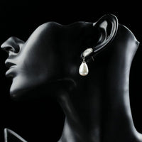 Side angle view of KHAISTA designer pearl drop earrings