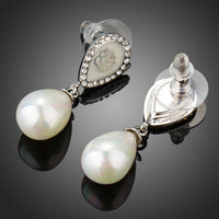 Close up of KHAISTA designer pearl drop earrings
