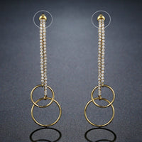 Side angle view of KHAISTA double circle crystal drop earrings
