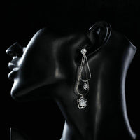 Close up of KHAISTA double flower crystal drop earrings