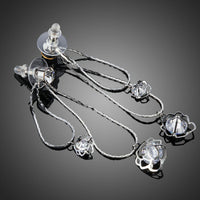 Side angle view of KHAISTA double flower crystal drop earrings